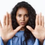 Victim abuse, danger and women concept. Close-up alarmed and serious-looking african american curly-haired woman stretch hands forward in stop motion, say no, enough, rejecting something.