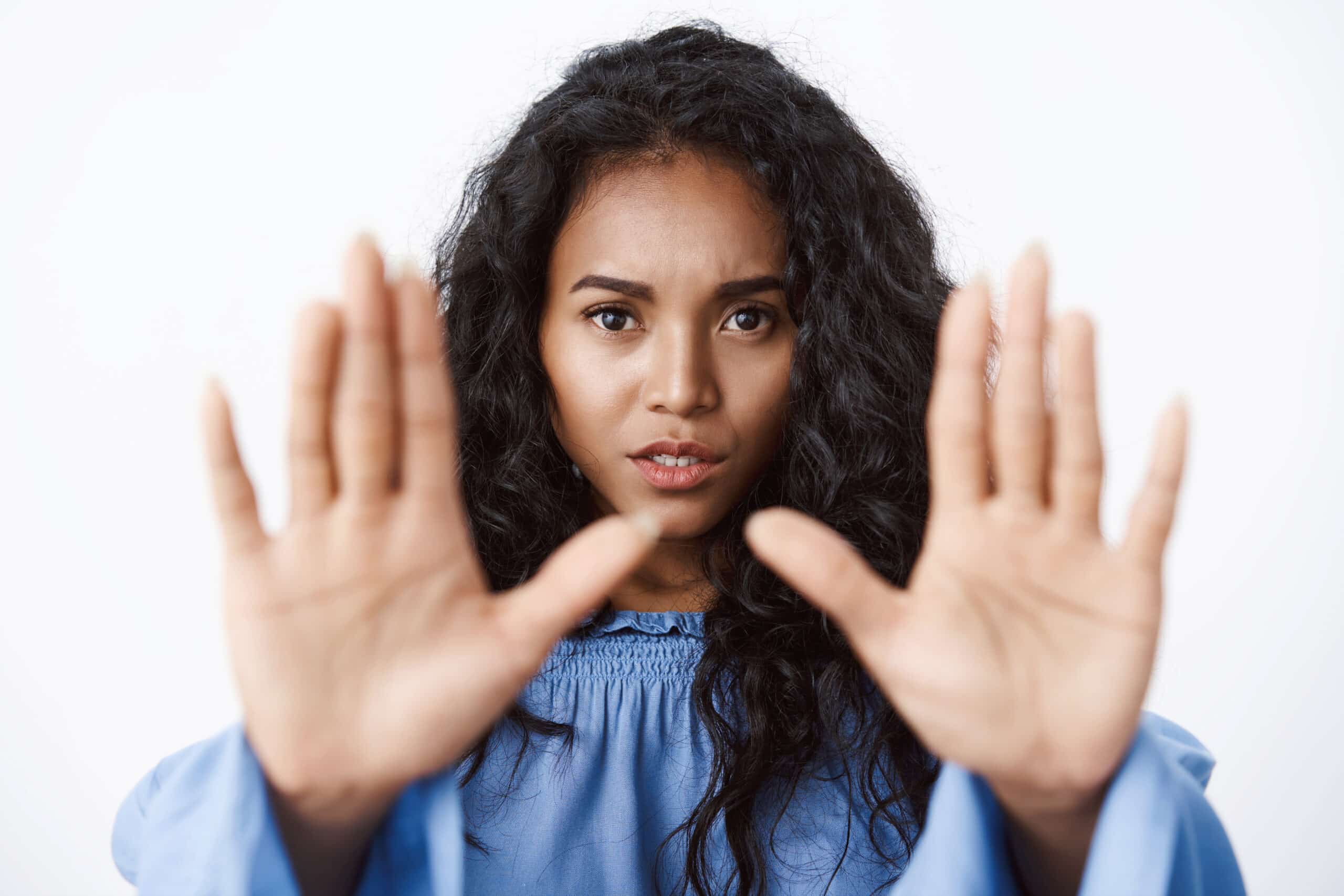 Victim abuse, danger and women concept. Close-up alarmed and serious-looking african american curly-haired woman stretch hands forward in stop motion, say no, enough, rejecting something.